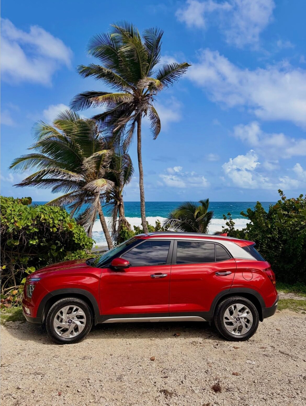 Red Hyundai Creta photographed beside the coast in Barbados