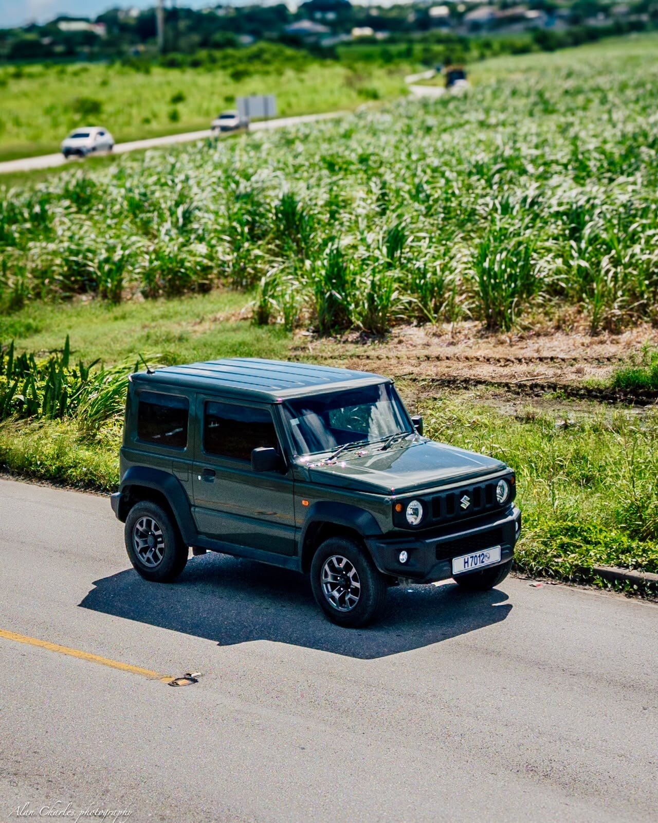 Actual green Suzuki Jimny from the 360 Car Rentals fleet driving through Barbados