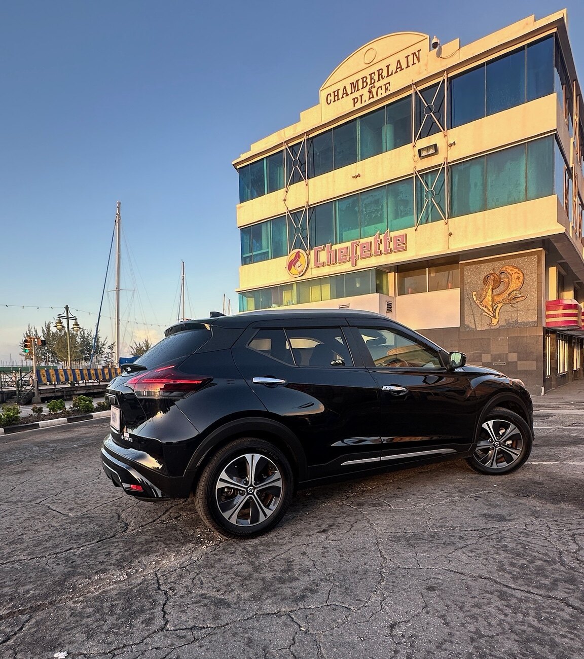 Rear side view of the black Nissan Kicks near the Bridgetown waterfront