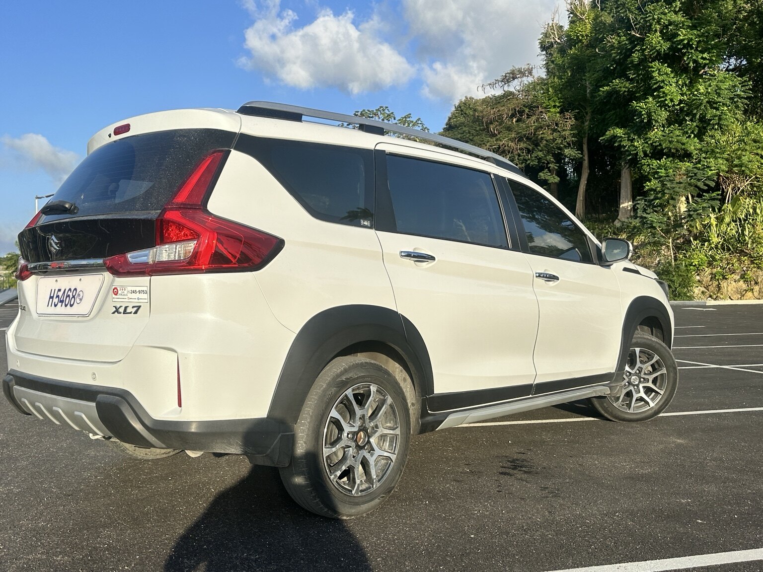 Rear side view of the white Suzuki XL7