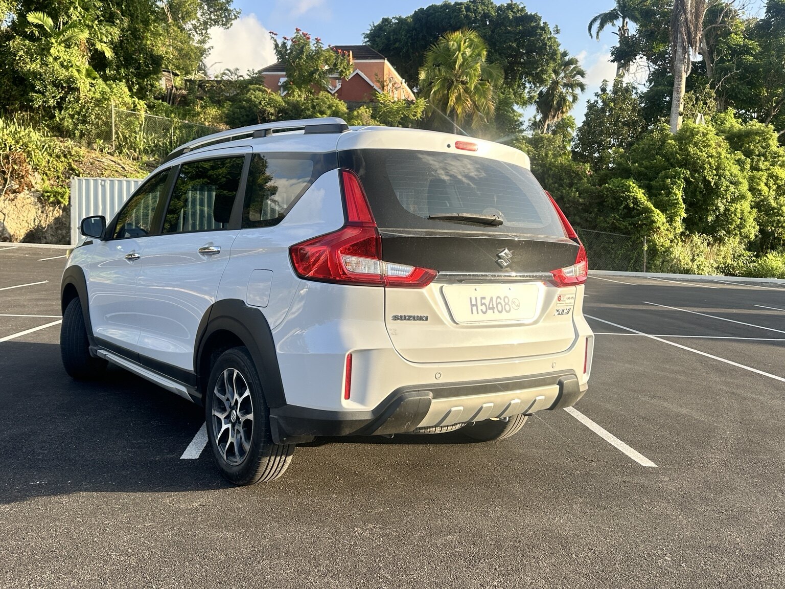 Rear exterior view of the white Suzuki XL7