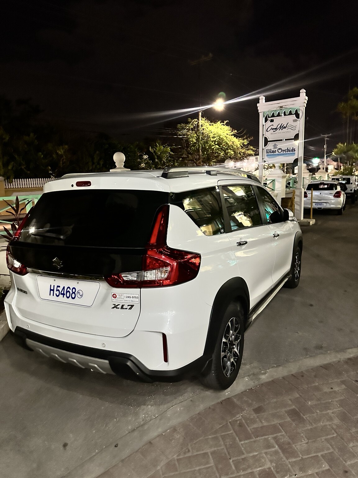 White Suzuki XL7 photographed in the evening